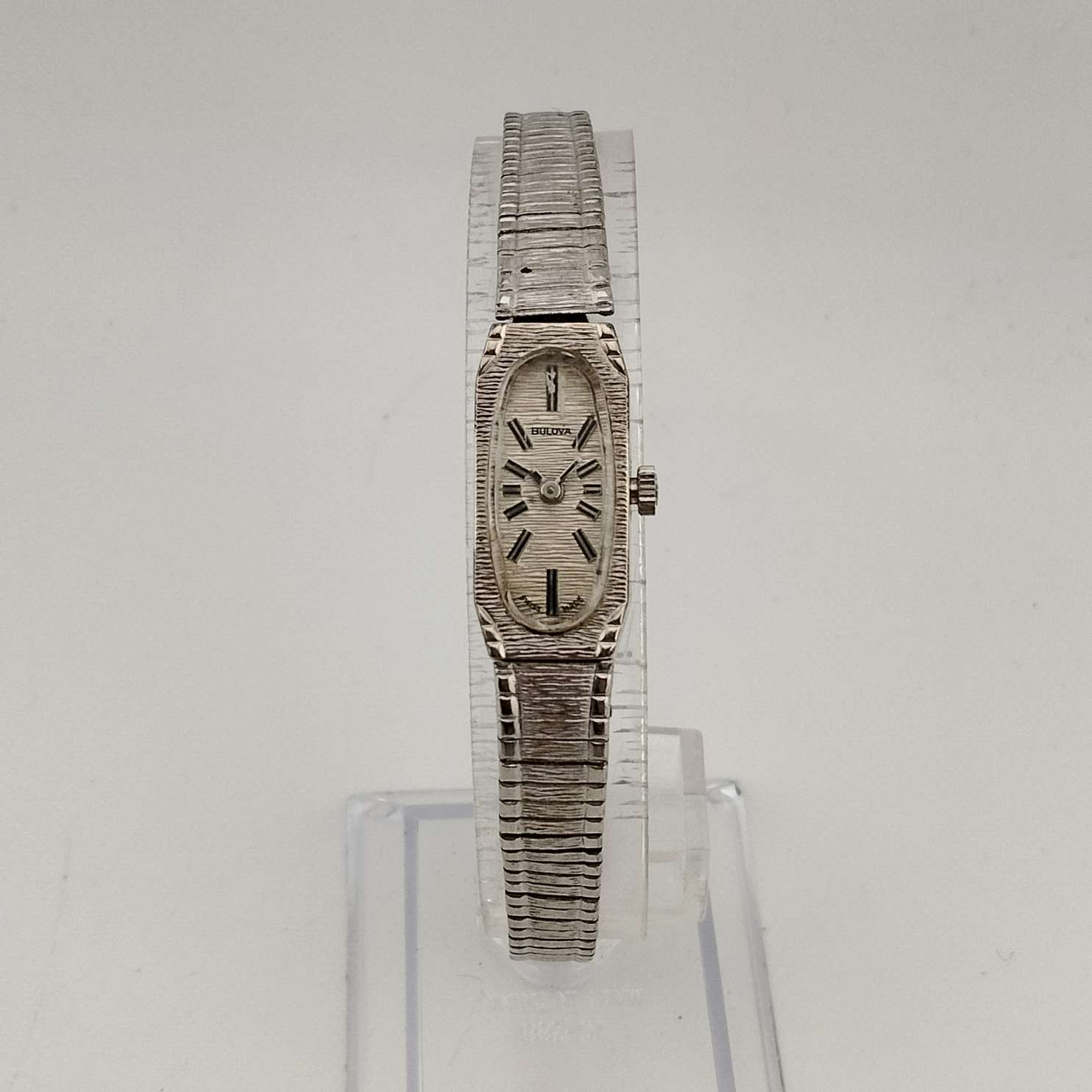 Bulova Women's  Petite Silver Tone Watch, Elongated Oval Dial, Stripe Patterning, Adjustable Bracelet Strap