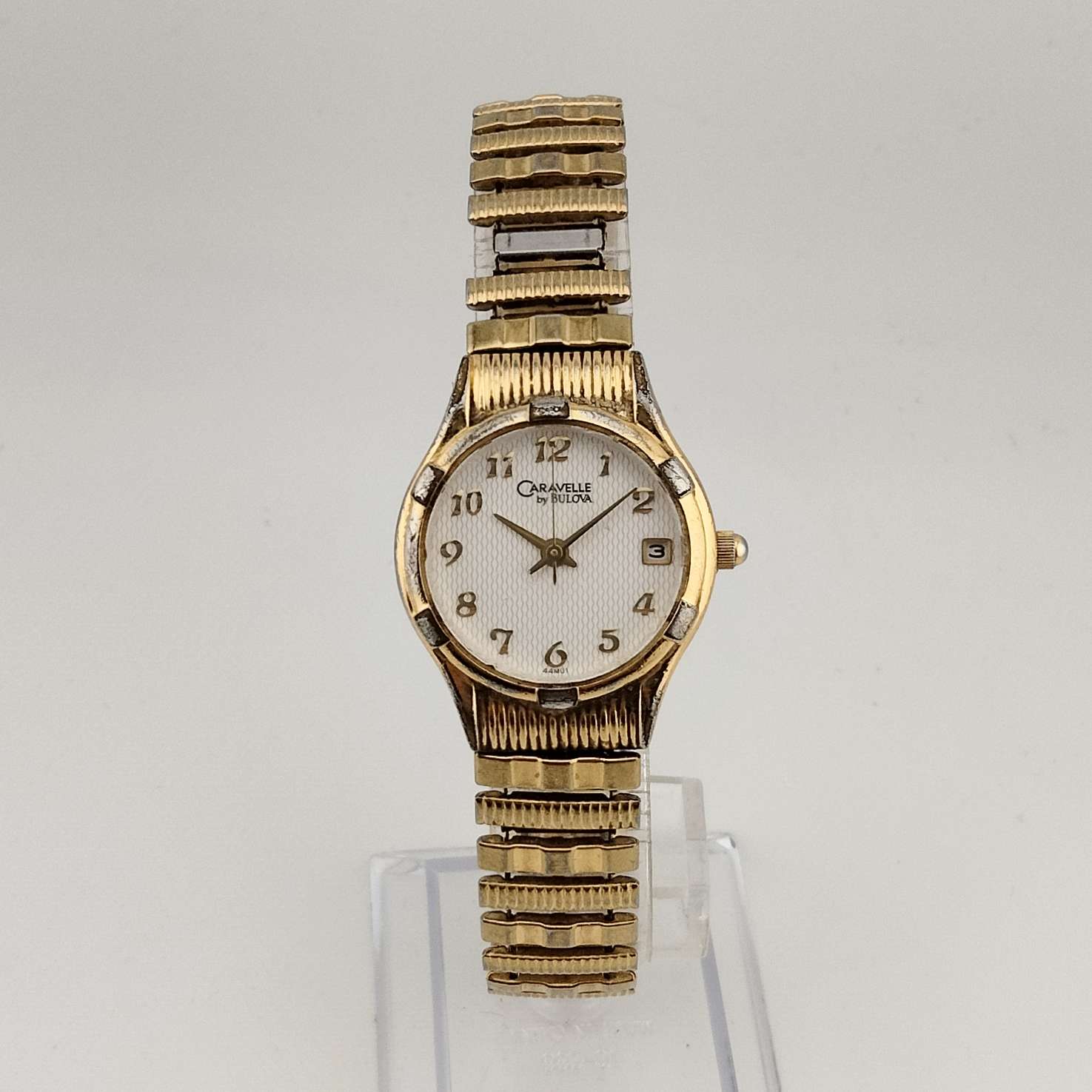 Caravelle by Bulova Unisex Gold Tone Quartz Watch, White Round Dial, Date Window, Stretch Strap