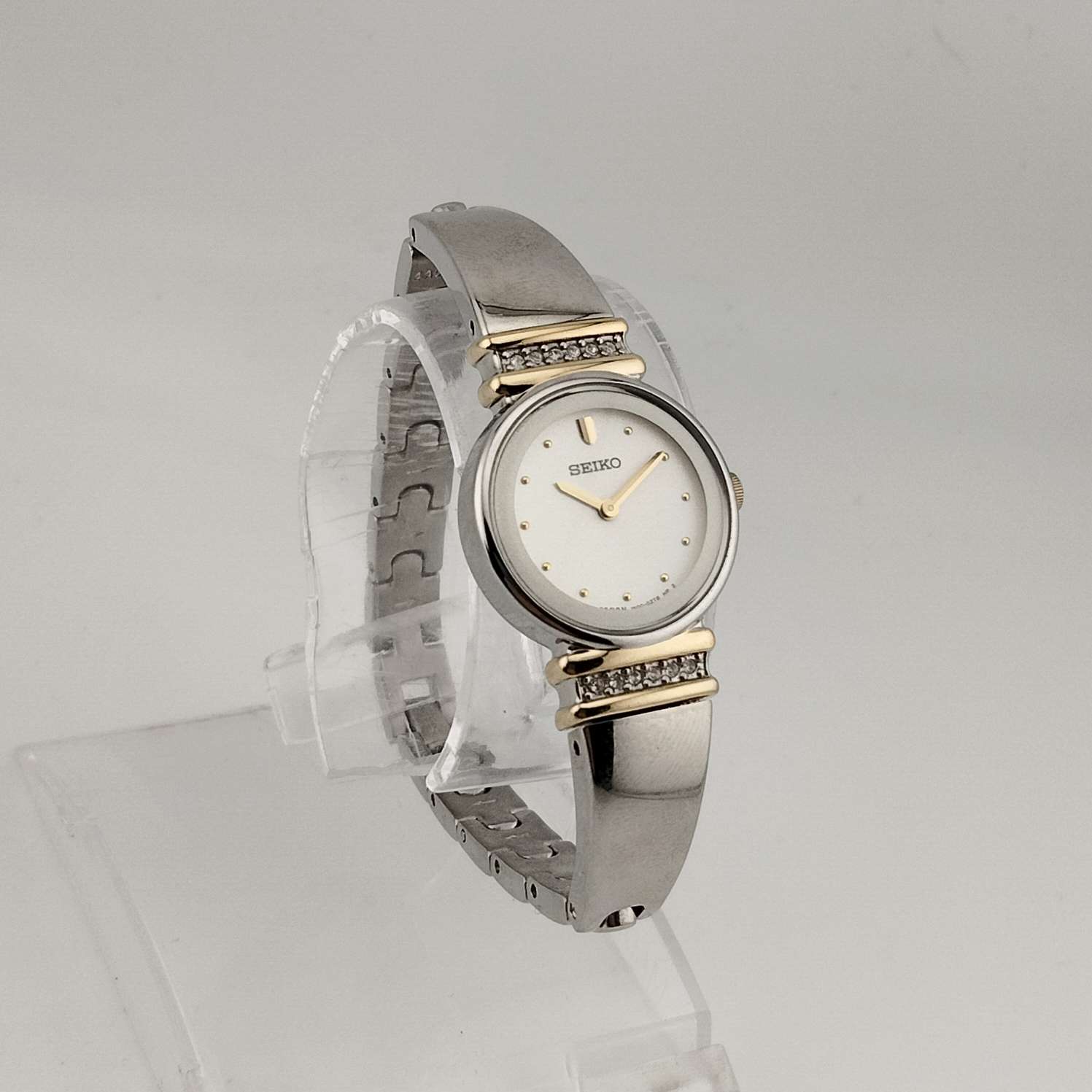 Seiko Women's Silver Tone Watch, Gold Tone Details, Round White Face, Jewel Bezel Details, Bracelet Strap